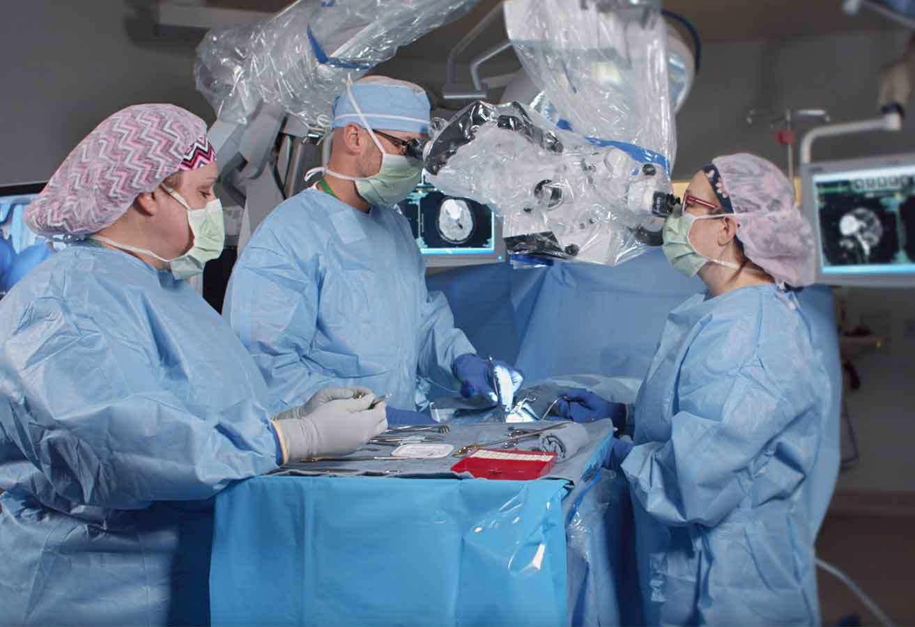 Brain surgeons performing a procedure on a patient.