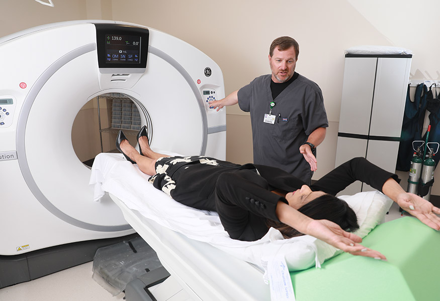 A business woman getting a CT scan done. 