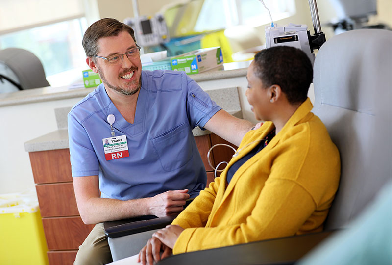 Registered nurse smiling with a patient.