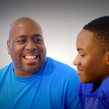 Rodney Harmon, smiling with his son.