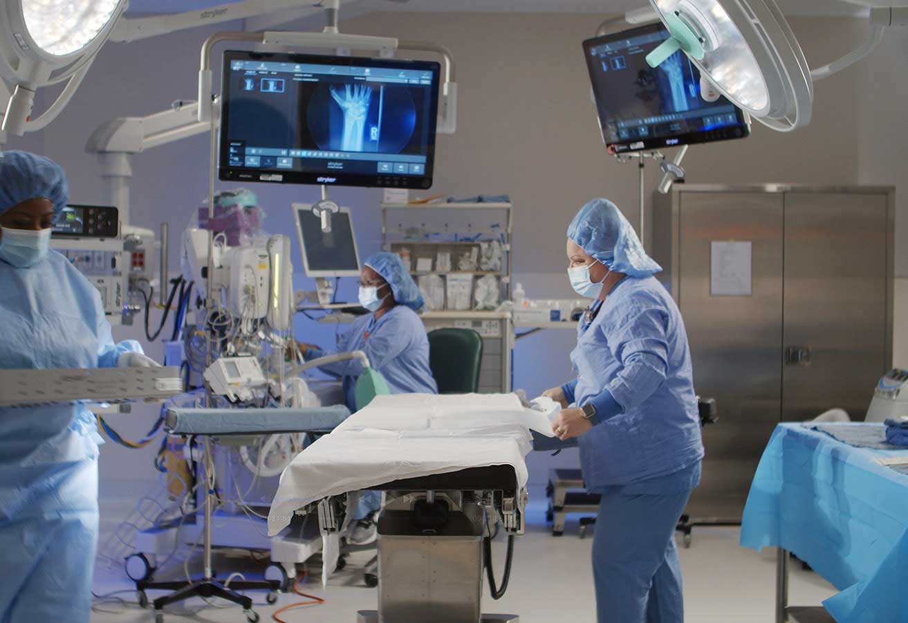 Surgeons prepping an operating room.