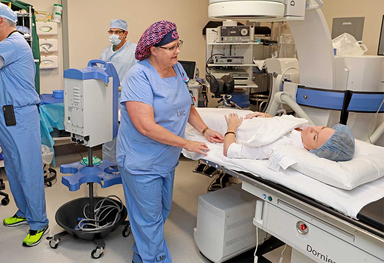Nurse helping a patient prepare for a procedure.